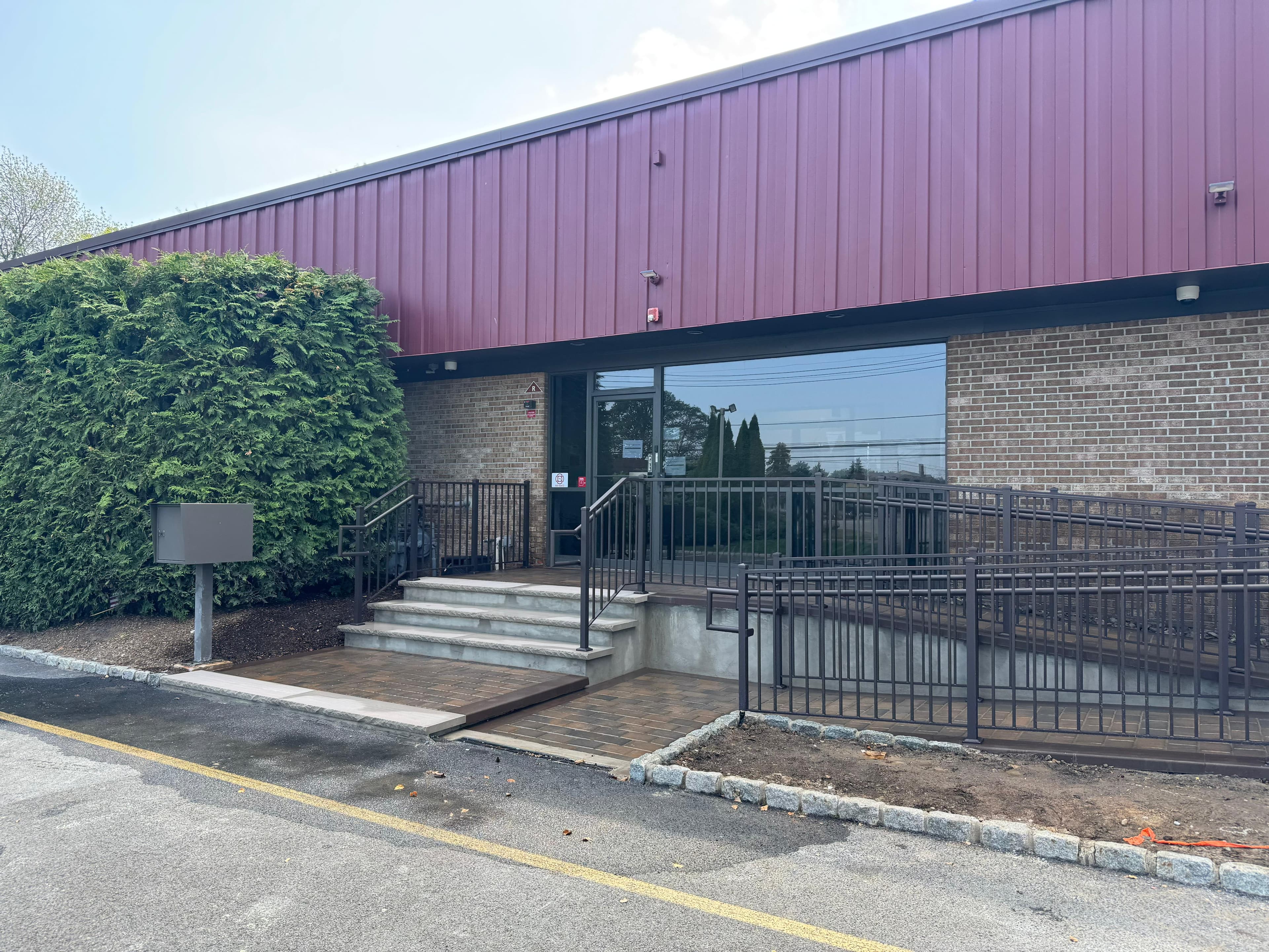 Published portfolio reference showing an entrance stair, ramp and pedestrian gate
